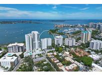 A scenic aerial view of waterfront condos with beautiful bay views, marina, and city skyline in the background at 555 S Gulfstream Ave # 804, Sarasota, FL 34236