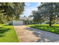 Single-Gathering home with a large, lush lawn and a two-car garage at 313 147Th E St, Bradenton, FL 34212