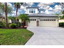Two-story house with two-car garage and landscaping at 13814 Nighthawk Ter, Lakewood Ranch, FL 34202