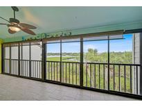 Enclosed balcony featuring neutral tile, large windows with a beautiful outdoor view and a ceiling fan at 1026 Bird Bay Way # 276, Venice, FL 34285