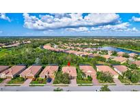 Aerial view of a single-Gathering home in a residential community with a lake at 9019 Heritage Sound Dr, Bradenton, FL 34212