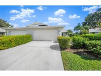 Front view of house with 2 car garage and landscaped yard at 6052 Bonaventure Pl, Sarasota, FL 34243