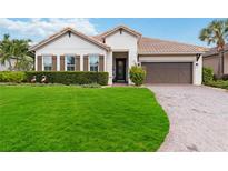 Charming one-story home with a welcoming front yard and landscaping at 4833 Tobermory Way, Bradenton, FL 34211