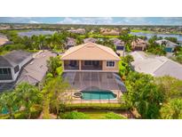 Aerial view of a backyard pool with a screened lanai and lush landscaping, creating a private outdoor oasis at 5120 Tidewater Preserve Blvd, Bradenton, FL 34208