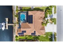 Aerial view of waterfront home with pool and dock at 8784 Mystic Cir, North Port, FL 34287