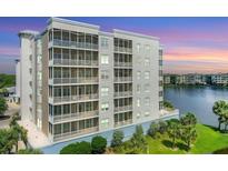 Luxury condo building with lake views at sunset at 10520 Boardwalk Loop # 605, Lakewood Ranch, FL 34202