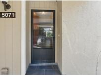 Front door with black frame and tile landing outside the entryway at 5071 Village Gardens Dr # 5, Sarasota, FL 34234