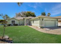 Light green house with a two-car garage at 5018 25Th E St, Bradenton, FL 34203