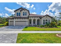 Two-story home with a three-car garage and attractive landscaping at 14607 Swiss Bridge Dr, Lithia, FL 33547