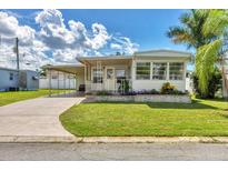 Charming single-story home with a carport and well-maintained lawn at 718 50Th Avenue W Dr, Bradenton, FL 34207