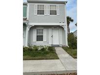 Two-story townhouse featuring a well-maintained front yard and a light gray exterior with white trim at 4629 Sabal Key Dr # 4629, Bradenton, FL 34203