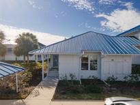 Charming single-story home with a blue metal roof and well-maintained landscaping at 835 Audubon Dr # 835, Bradenton, FL 34209