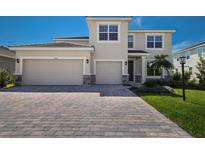 Two-story house with a two-car garage and paver driveway at 4322 Silo Port Ct, Lakewood Ranch, FL 34211