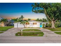 Charming single story home with a blue door and spacious yard at 21288 Edgewater Dr, Port Charlotte, FL 33952