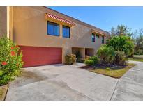 Tan colored condo building with red garage door at 4013 Catalina Dr # 4013, Bradenton, FL 34210