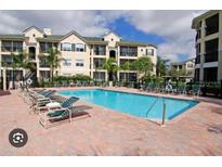 Relaxing community pool with plenty of lounge chairs for residents at 5152 Northridge Rd # 302, Sarasota, FL 34238