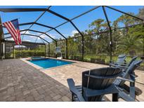 Inviting screened pool area with lounge chairs and a basketball hoop at 16215 Tradewind Ter, Lakewood Ranch, FL 34211