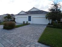 Stunning three-car garage home with a paved driveway at 7624 Registrar Way, Sarasota, FL 34243