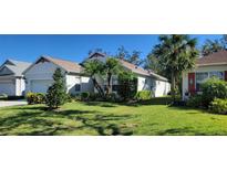 Single-story home with attached garage and lush landscaping at 4808 Charles Partin Dr, Parrish, FL 34219