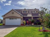 Charming home featuring a two-car garage, well-manicured lawn, and screened-in patio perfect for relaxing at 7209 49Th E Pl, Palmetto, FL 34221