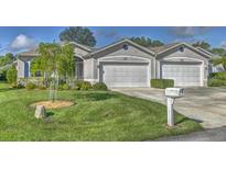 Charming single-story home featuring a manicured lawn and attached two-car garage at 1362 Hedgewood Cir, North Port, FL 34288