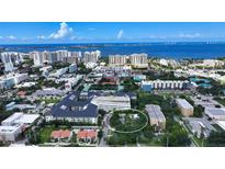 Aerial view of a house and surrounding neighborhood, showcasing the property's location and proximity to other buildings at 1569 7Th St, Sarasota, FL 34236