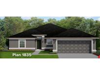 One-story house with gray exterior and two-car garage at 4784 Badosa Rd, North Port, FL 34286