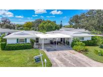 Aerial view of two-unit home with carport, landscaping, and surrounding neighborhood at 3276 Westford Ln, #117,, Sarasota, FL 34231