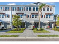 Beautiful townhome exteriors showcasing a modern facade, complemented by well-manicured landscaping and inviting entrances at 1625 Compass Pointe Ct # 105, Punta Gorda, FL 33950