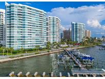 Stunning waterfront condo building with boat docks, offering luxurious living and beautiful water views at 988 Blvd Of The Arts # 810, Sarasota, FL 34236