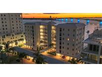 Luxury condo building with waterfront views and sunset at 226 Golden Gate Pt # 64, Sarasota, FL 34236