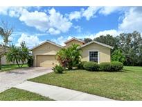 Tan one-story house with two-car garage and landscaped yard at 4412 67Th E St, Bradenton, FL 34203