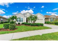 Charming single-story home features a manicured front yard with tropical landscaping and a welcoming entrance at 12715 Lake Silver Ave, Bradenton, FL 34211