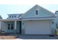 Inviting light blue home with a wide two-car garage and paver driveway at 705 Anegada Ln, Sarasota, FL 34234