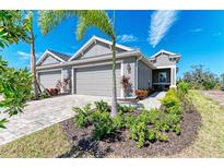 Modern two-car garage home with landscaping at 4133 Golden Creek Ter, Parrish, FL 34219