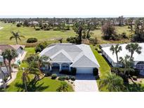 Aerial view of single-Gathering home with a paved driveway and lush landscaping at 48 Sportsman Ct, Rotonda West, FL 33947