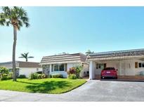 Front view of a single-story home with attached carport at 2607 Riverbluff Pkwy # V145, Sarasota, FL 34231