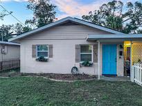 Charming one-story home with a light beige exterior and a bright blue door at 1106 26Th Ave W, Bradenton, FL 34205