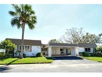 Condo exterior, carport, palm tree at 2020 Riverbluff Pkwy # V329, Sarasota, FL 34231