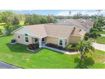 Tan one-story house with brown roof, landscaping, and a view of the neighborhood at 4344 Edinbridge Cir # 1, Sarasota, FL 34235