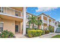 Two-story building with balconies and lush landscaping at 4210 Caddie E Dr # 102, Bradenton, FL 34203