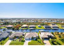 Aerial view of a canal-front community with single-Gathering homes at 15912 Melport Cir, Port Charlotte, FL 33981