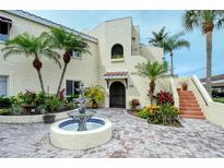 Mediterranean-style building with courtyard fountain, inviting entryway, and lush landscaping at 6101 34Th W St # 15B, Bradenton, FL 34210