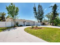 Charming single-story home with a well-manicured lawn and a circular driveway at 1012 Myrtle Ave, Venice, FL 34285