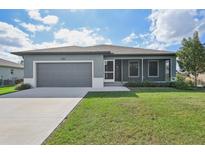 Single story home with gray exterior and screened porch at 11213 Gulfstream Blvd, Port Charlotte, FL 33981