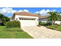 Single-story house with a two-car garage and a well-manicured lawn at 3924 Alamanda Dr, Sarasota, FL 34238