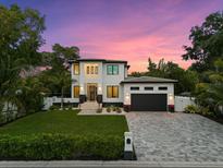 Modern two-story home with a paved driveway and landscaped yard at 577 Venice Ln, Sarasota, FL 34242
