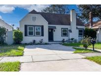 Charming single-story home featuring a concrete driveway, chimney, and neutral paint scheme at 918 45Th N St, St Petersburg, FL 33713