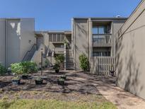 Condo building exterior featuring a courtyard and landscaping at 232 Woodland Dr, Osprey, FL 34229