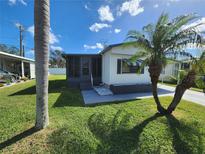 Single-wide manufactured home with carport and landscaped lawn at 808 53Rd E Ave # 8, Bradenton, FL 34203